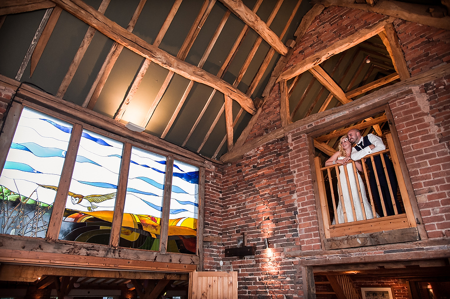 Creative evening portrait showing beautiful Oat Barn with Bride and Groom at Packington Moor in Lichfield by Lichfield Contemporary Wedding Photographer Barry James