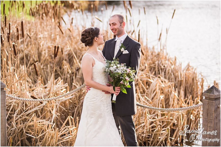 Creative personal portraits of bride and groom by the lake at The Moat House in Acton Trussell by Stafford Wedding Photographer Barry James