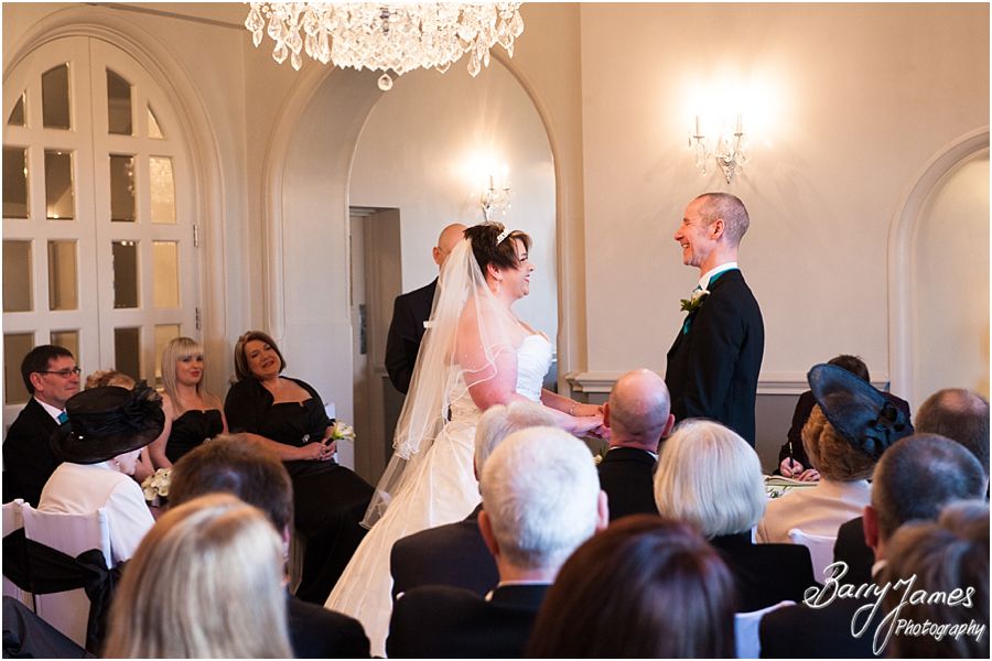 Reportage photographs during wedding ceremony in Shrewsbury Suite at Weston Hall in Stafford by Recommended Staffordshire Wedding Photographer Barry James