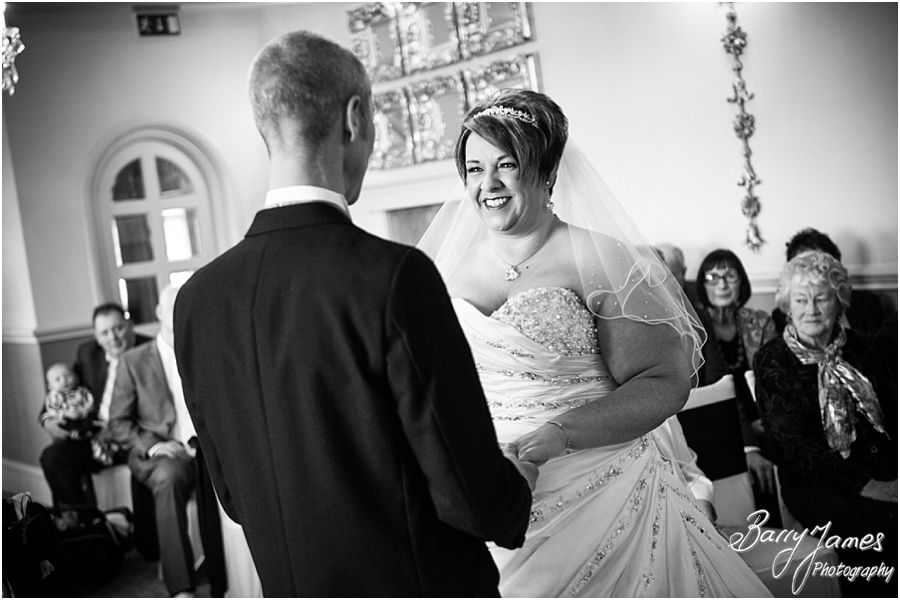 Unobtrusive photographs of wedding ceremony in Shrewsbury Suite at Weston Hall in Stafford by Recommended Staffordshire Wedding Photographer Barry James