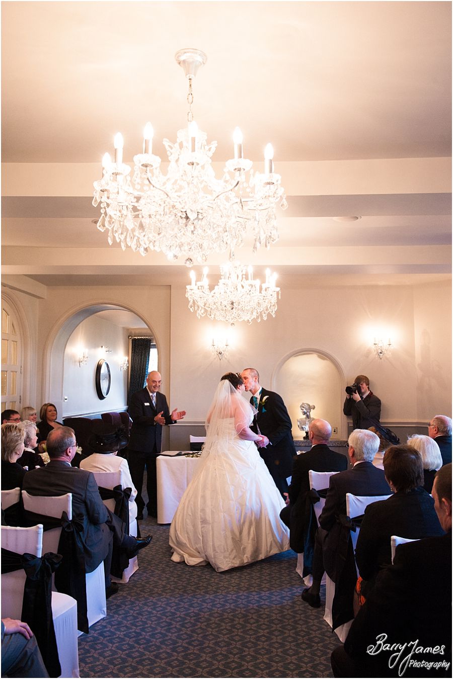Reportage photographs during wedding ceremony in Shrewsbury Suite at Weston Hall in Stafford by Recommended Staffordshire Wedding Photographer Barry James