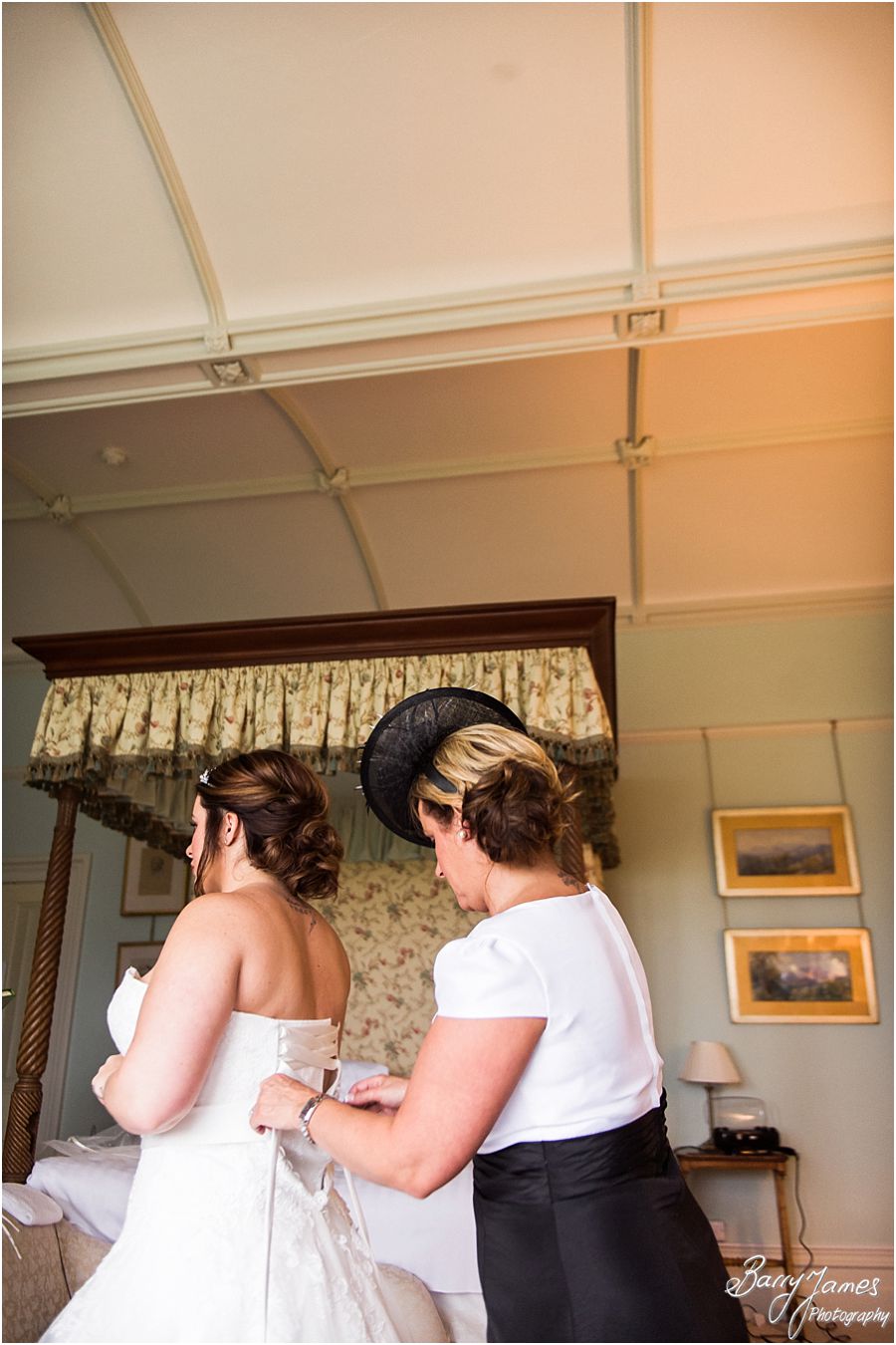 Candid photography of Bride getting ready for the wedding in her beautiful gown at Heath House in Tean by Award Winning Stoke-on-Trent Wedding Photographer Barry James