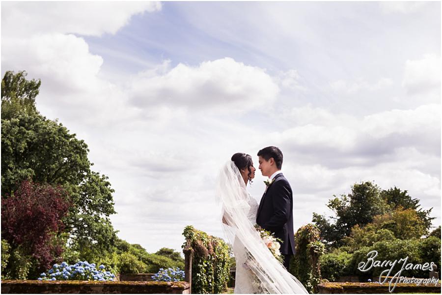 Elegant and natural photographs of the bride and groom around the gardens at Sandon Hall in Stafford by Stafford Wedding Photographer Barry James