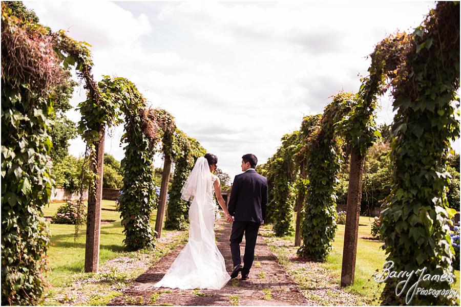 Elegant and natural photographs of the bride and groom around the gardens at Sandon Hall in Stafford by Stafford Wedding Photographer Barry James