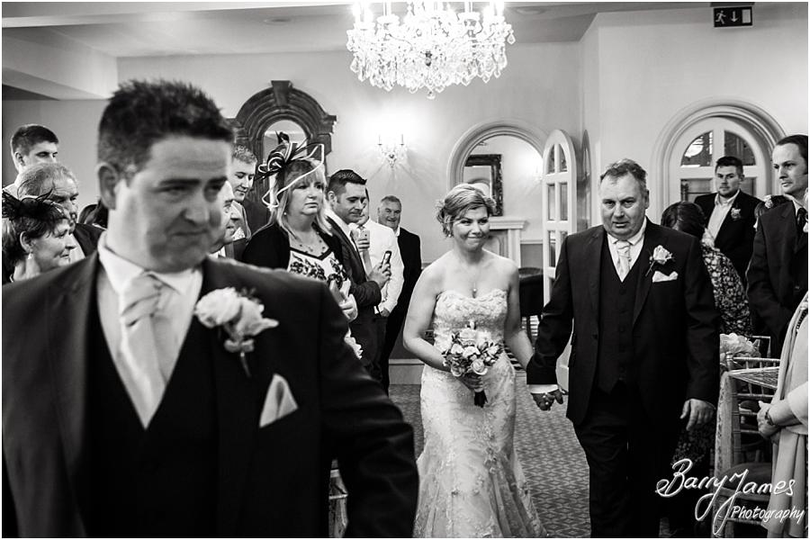 Candid photographs of the nervous groom and entrance of the beautiful bride at Weston Hall in Stafford by Stafford Wedding Photographer Barry James
