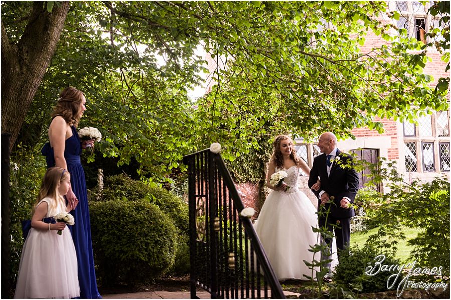 Candid photographs of the intimate outdoor ceremony at Albright Hussey Manor in Shrewsbury by Contemporary Wedding Photographer Barry James
