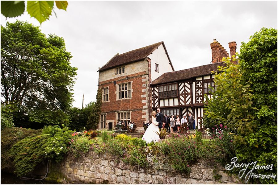 Creative bride and groom portraits around the wonderful gardens at Albright Hussey Manor in Shrewsbury by Contemporary Wedding Photographer Barry James