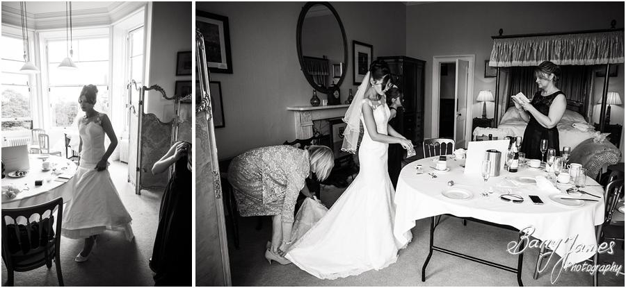Unobtrusive candid photos of the bridal dressing in her gown at Sandon Hall in Stafford by Stafford Wedding Photographer Barry James