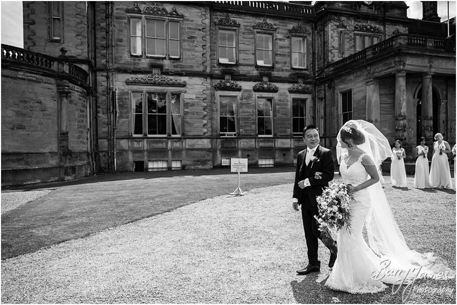 Creative natural photos that capture the arrival of the beaming bride and her father at Sandon Hall in Stafford by Stafford Wedding Photographer Barry James