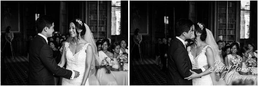 Two photographs covering the wedding ceremony in the library, candidly capturing the story of the wedding at Sandon Hall in Stafford by Stafford Wedding Photographer Barry James