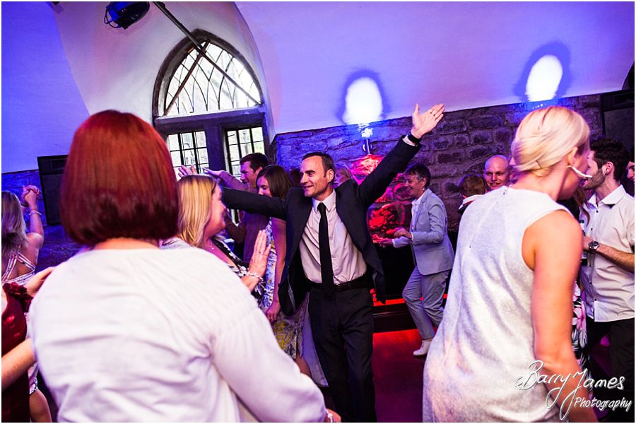Photographs that capture the fun of the wedding party in the cellar at Clearwell Castle in Gloucestershire by Gloucester Wedding Photographer Barry James