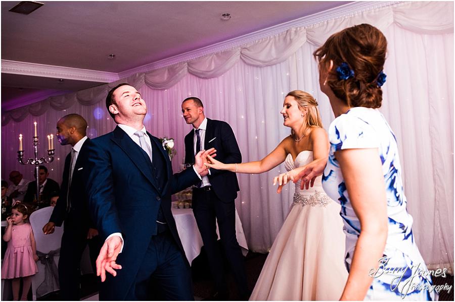 Creative candid photos of the wedding guests enjoying the reception at The Moat House in Acton Trussell by Wolverhampton Wedding Photographer Barry James